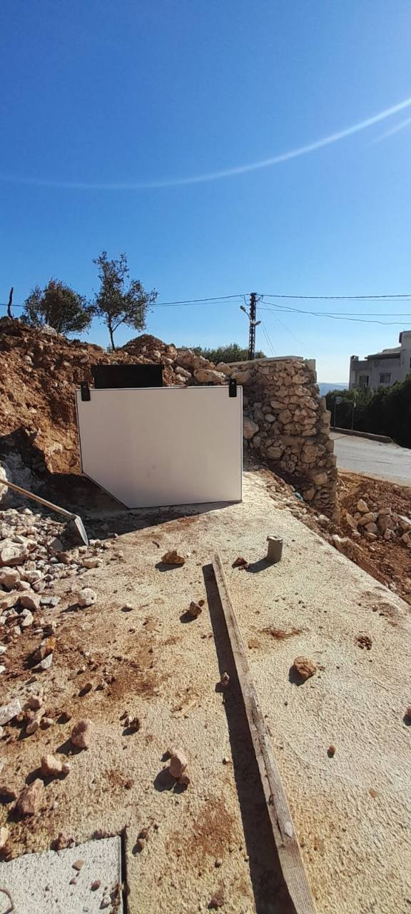 Hy-Series plant positioned beside a stone wall in a residential setting